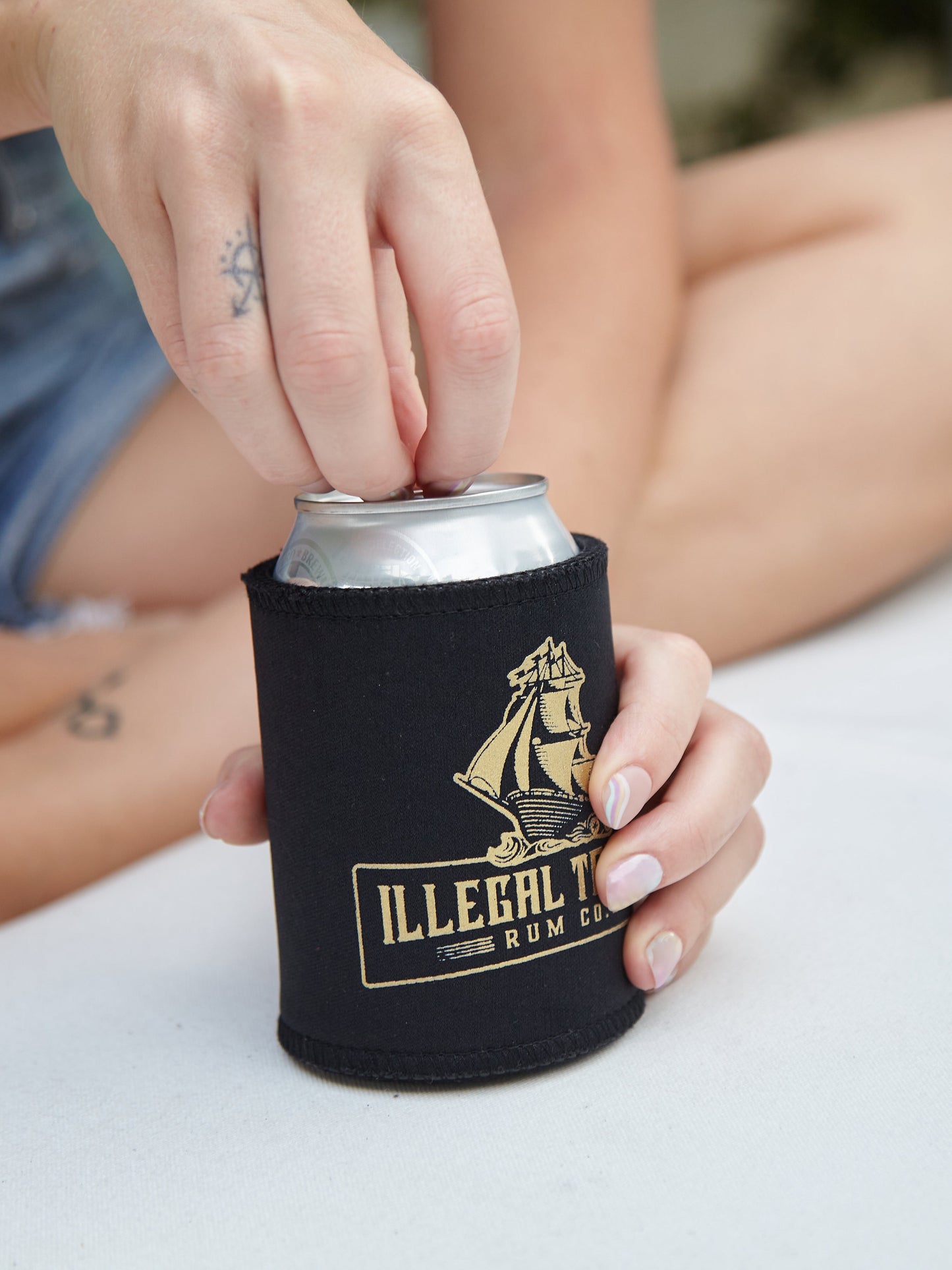 Hand opening drink in cooler