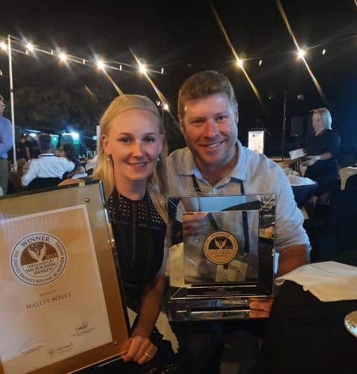 Award winners holding rum industry trophies