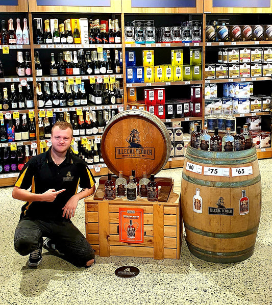 Man with Illegal Tender Rum product collection at BWS Wonthella.